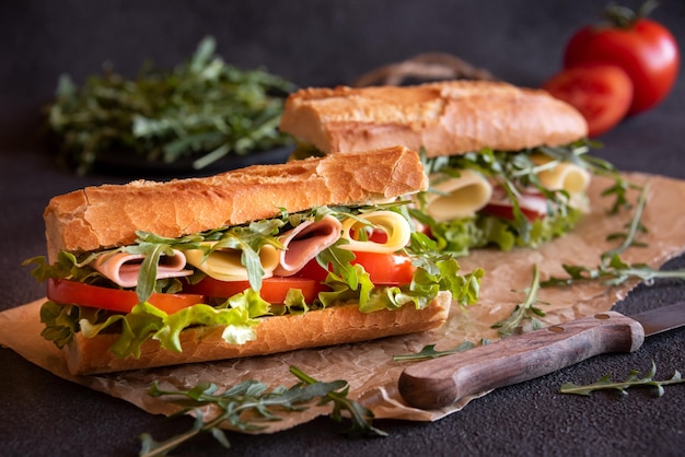Baguette sandwich with cheese ham tomatoes and vegetables