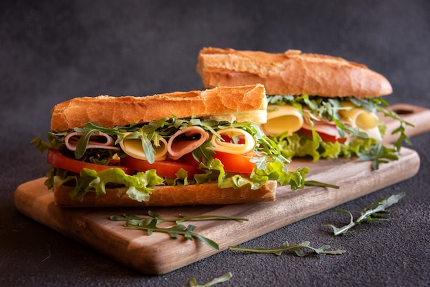 Baguette sandwich with cheese ham tomatoes and vegetables