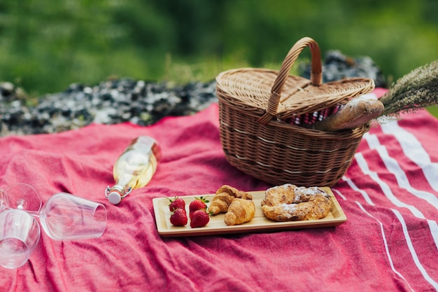 Baguette strawberries wine croissants and basket