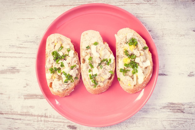 Baguette with fish paste on glass plate