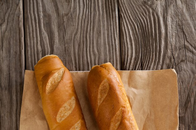 Baguettes on wooden background