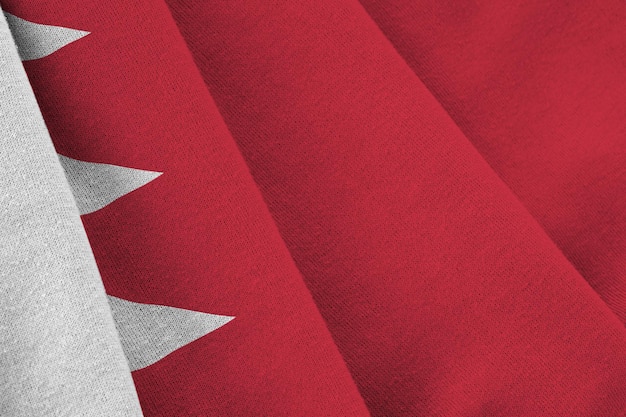 Bahrain flag with big folds waving close up under the studio light indoors The official symbols and colors in banner