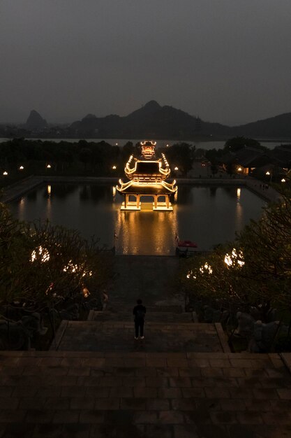 Bai Dinh Pagoda illuminates at night reflected in its beautiful pools Vietnams