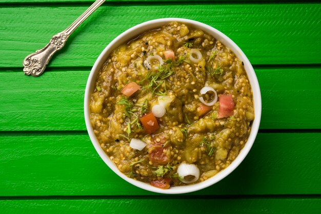 Baigan Bharta in hindi or Vangyache Bharit in marathi is a roasted and mashed eggplant fry or curry, favourite maharashtrian menu, served in a bowl or Karhai or pan. selective focus