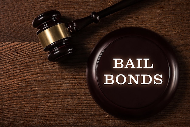 Bail bonds services concept. Judge gavel on wooden background.