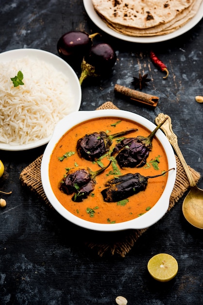 Baingan or baigan masala or Eggplant or brinjal curry served with chapati and rice, selective focus