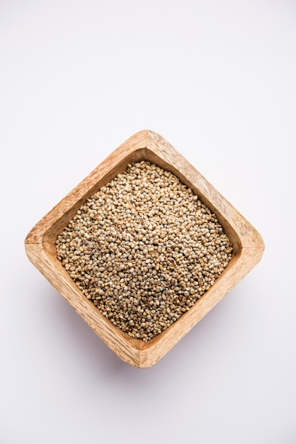 Bajra or pearl millet or sorghum grains in a bowl, selective focus