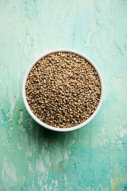 Bajra or pearl millet or sorghum grains in a bowl, selective focus