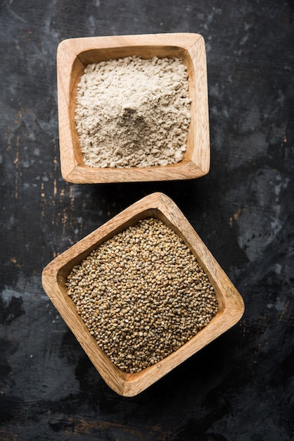 Bajra, pearl millet or sorghum grains with it's flour or powder in a bowl, selective focus