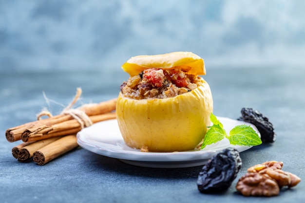 Photo baked apple stuffed with oatmeal, raisins and nuts