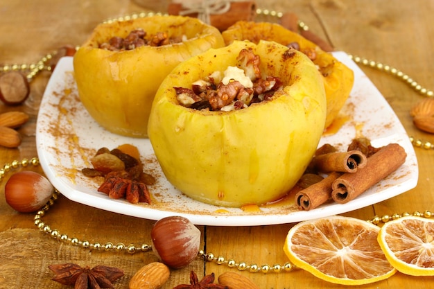 Baked apples on plate on wooden table