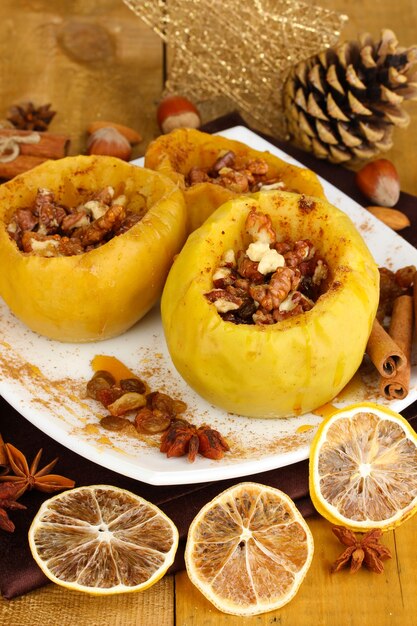 Baked apples on plate on wooden table