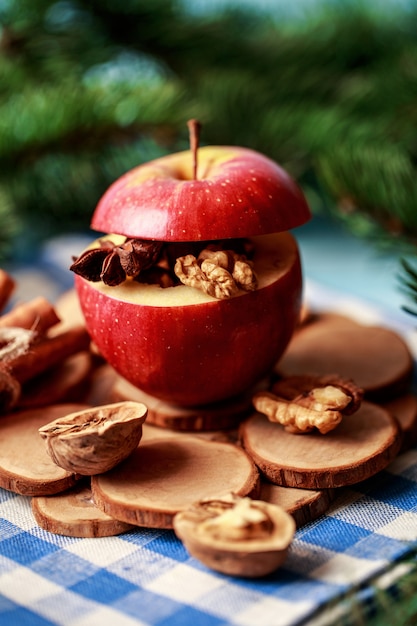 Baked apples with cinnamon on rustic background 