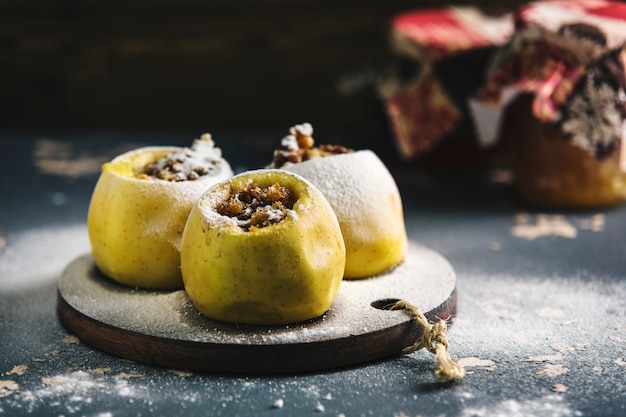 baked apples with honey on a dark wooden Board on dark  