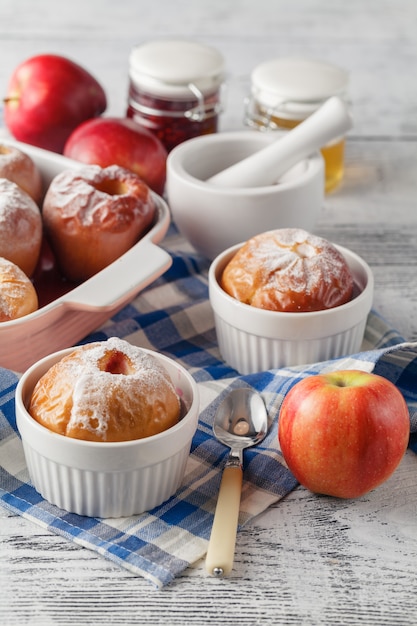 Baked apples on wooden table