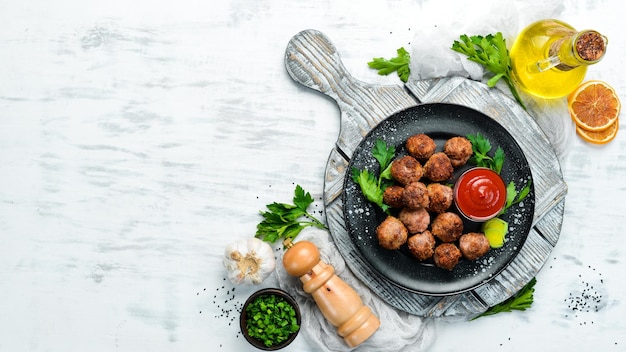 Baked Beef Meatballs with Ketchup on a Black Plate Top view Free space for your text