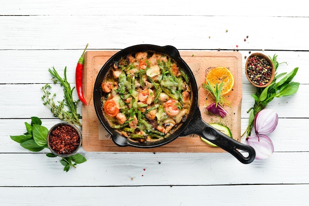 Baked beef with beans tomatoes and vegetables in a frying pan Top view Free space for your text