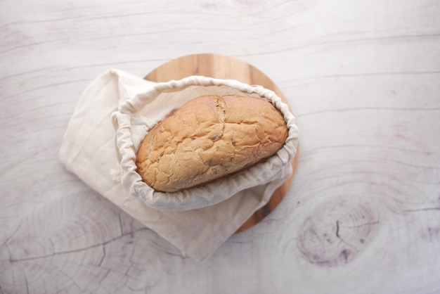 Baked bread stored in a reusable linen bag Eco friendly Zero waste concept