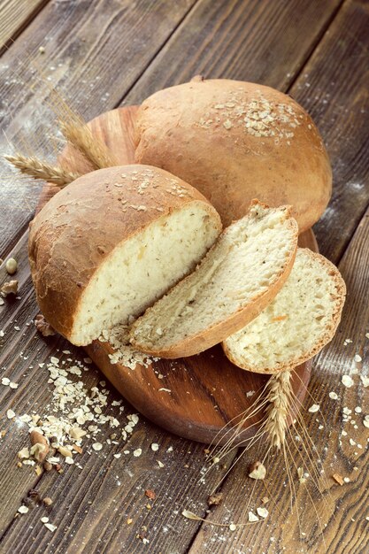 Baked bread on wooden table background