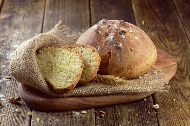 Baked bread on wooden table background