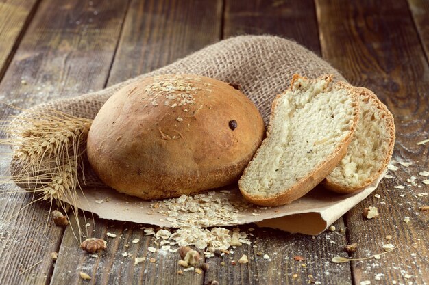 Baked bread on wooden table background