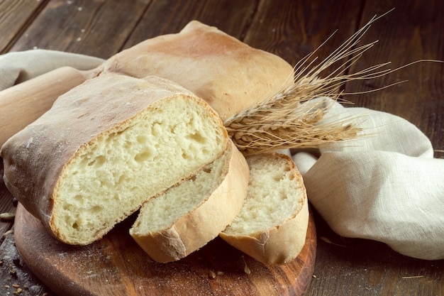 Baked bread on wooden table background