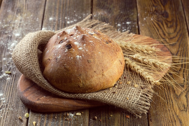 Baked bread on wooden table 