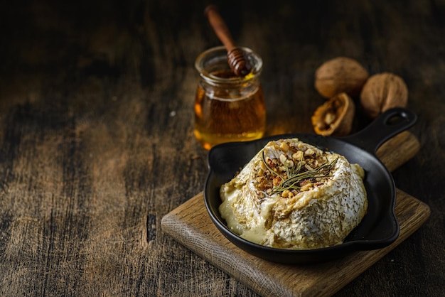 Baked brie cheese on a wooden board