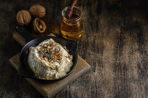 Baked brie cheese on a wooden board