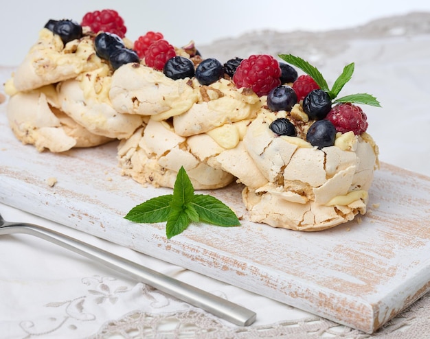 Baked cake made from whipped chicken protein and cream decorated with fresh berries Dessert Pavlova