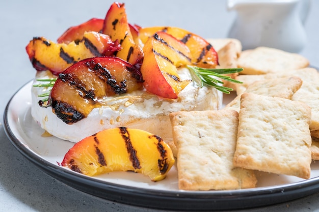 Baked Camembert cheese with grilled peach