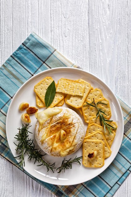 Baked camembert french soft cheese on white plate