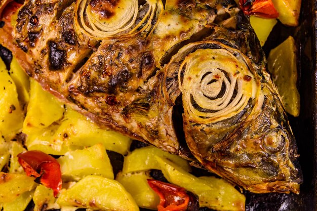 Baked carp fish with the potatoes and bell pepper Top view