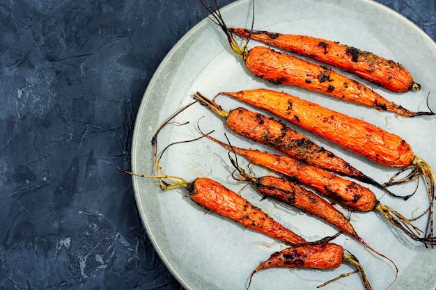 Baked carrots on a plate copy space