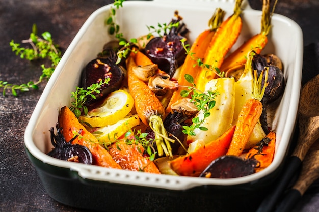 Baked carrots, sweet potatoes, beets and zucchini in oven dish.