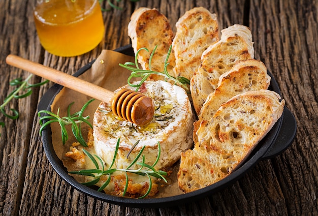 Baked cheese Camembert with rosemary and honey.