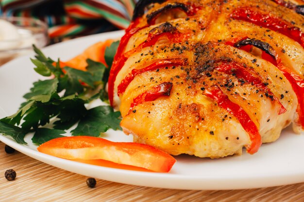 Baked chicken breast stuffed with pepper on a plate