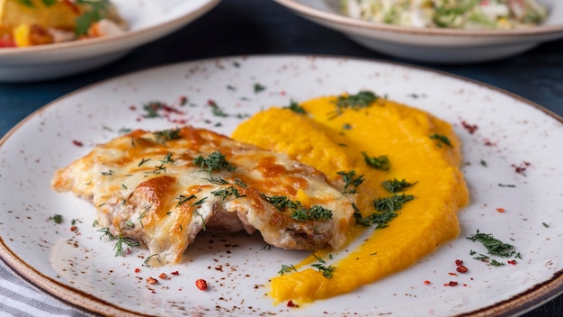 Baked chicken under cheese with carrot puree