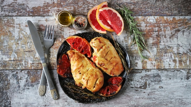 Baked chicken fillet with grapefruit and rosemary.