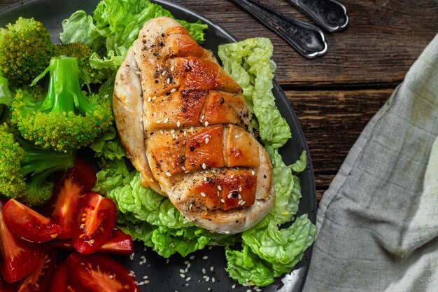 Baked chicken fillet with vegetables in a plate