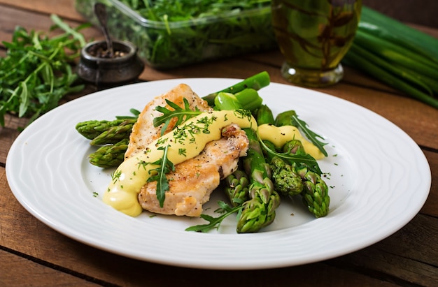 Baked chicken garnished with asparagus and herbs