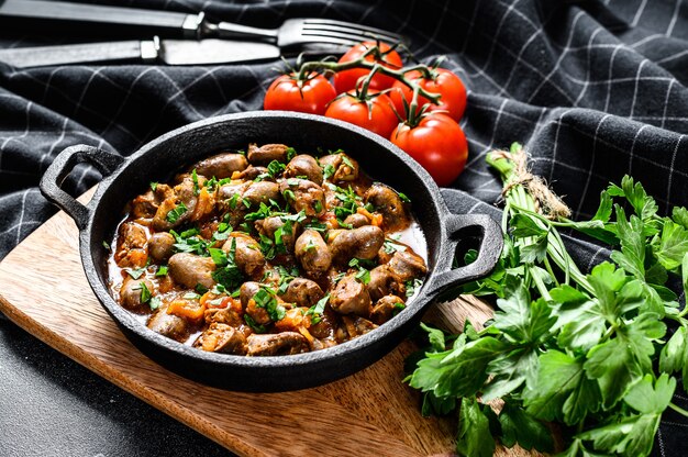 Baked chicken hearts with tomato sauce