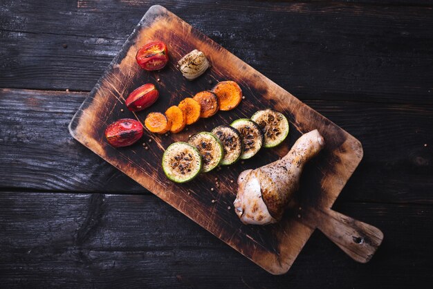 Baked chicken leg with crispy crust, delicious grilled vegetables