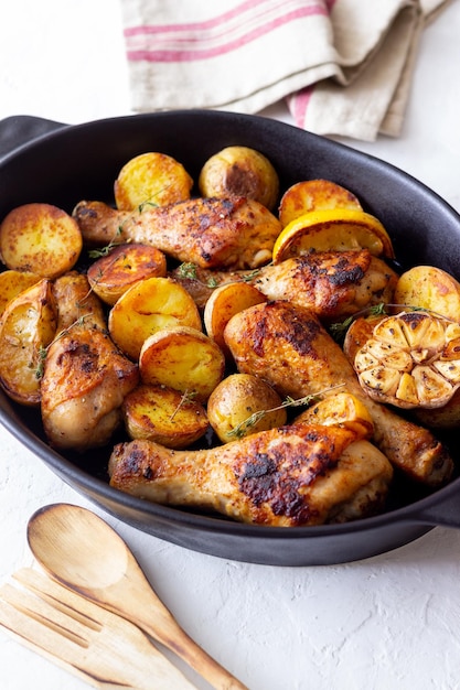 Baked chicken legs with potatoes and lemon Recipe