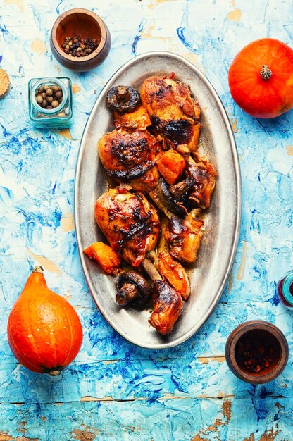 Baked chicken legs with pumpkin and mushrooms. Autumn meat recipe