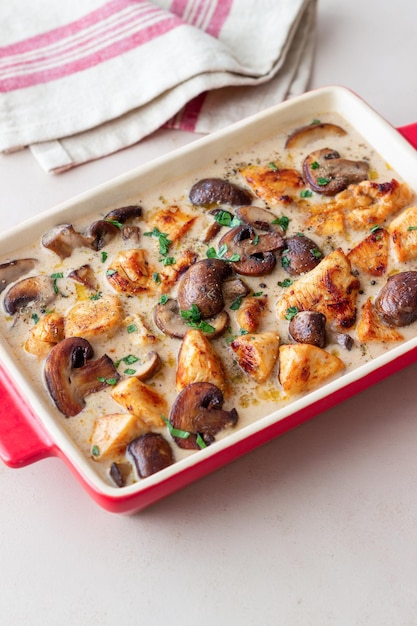 Baked chicken and mushrooms in a creamy sauce. french cuisine.\
fricassee.