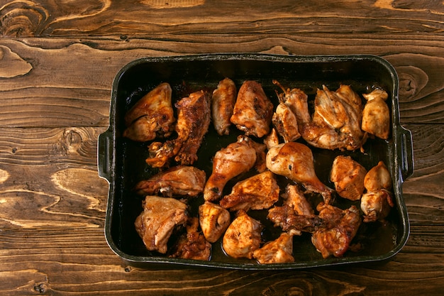 Baked chicken pieces on baking sheet