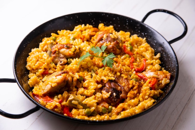 Baked chicken rice paella with vegetables. Traditional Spanish recipe.