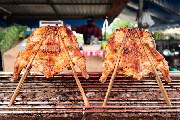 BAKED CHICKEN STREET FOODBAKE WHOLE CHICKEN READY TO EAT AND SALE IN MARKET BANGKOK THAILAND