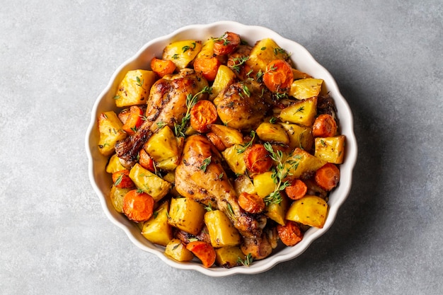 Baked chicken thighs and fried potatoes look delicious.